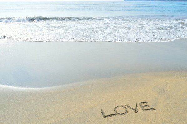 The inscription love on the seashore