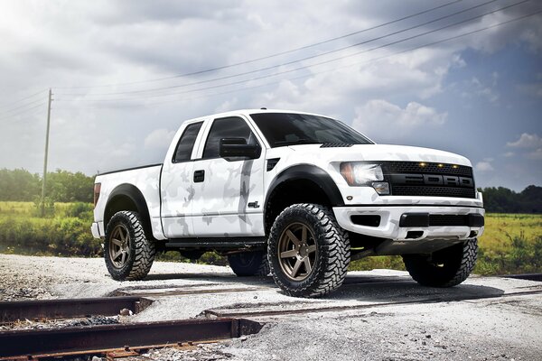 Ford Raptor white next to the railway