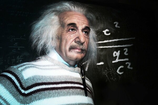 Albert Einstein on the background of a blackboard with formulas written on it