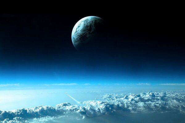 Красивое изображение в далеке планеты земля над облаками