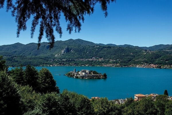 Landscape with an island in the middle of a lake and a forest