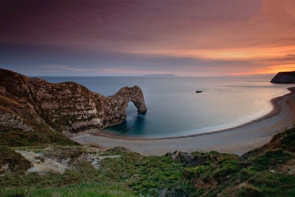 The sea coast at sunset. Sandy beach