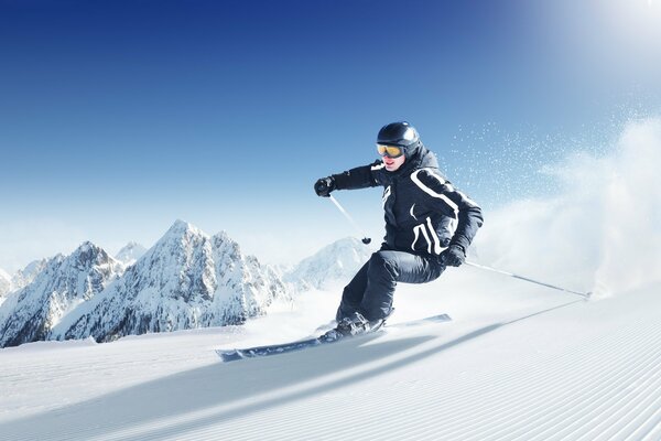 A skier on the slope of a snowy mountain