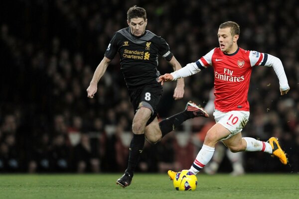 Le milieu de terrain Jack Wilshire sur le terrain Stephen Gerard