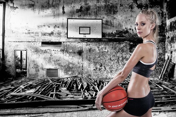 A girl with a basketball on a gloomy background