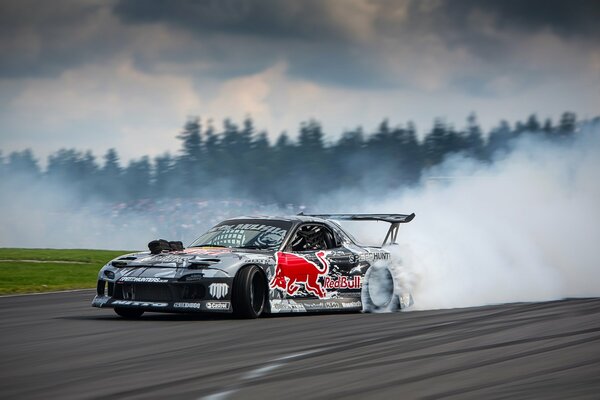 Mazda racing car in white smoke