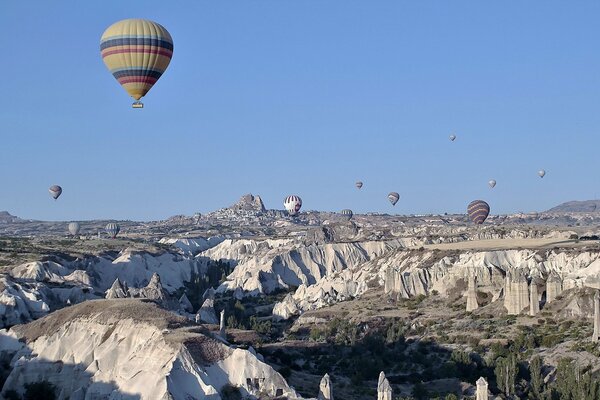 Balloons flying over rocks