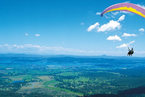 Paragliding with a view of nature. The high flight of man over the earth