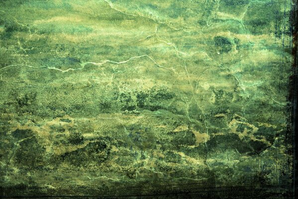 Fissures sur le mur vert. Peinture