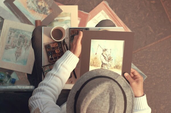 Photo of the artist with a picture on top