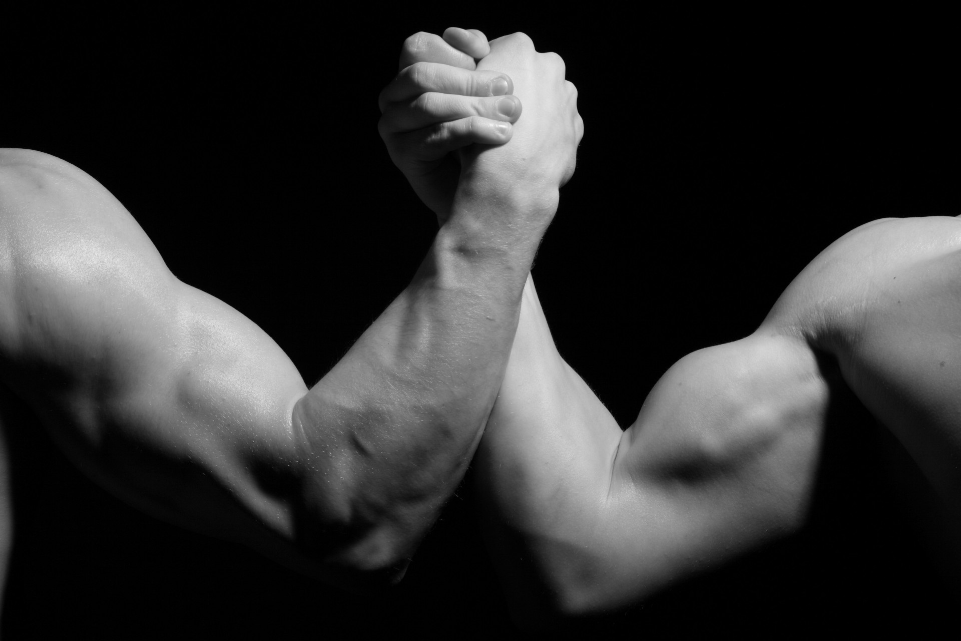 arm wrestling black and white men hands fight