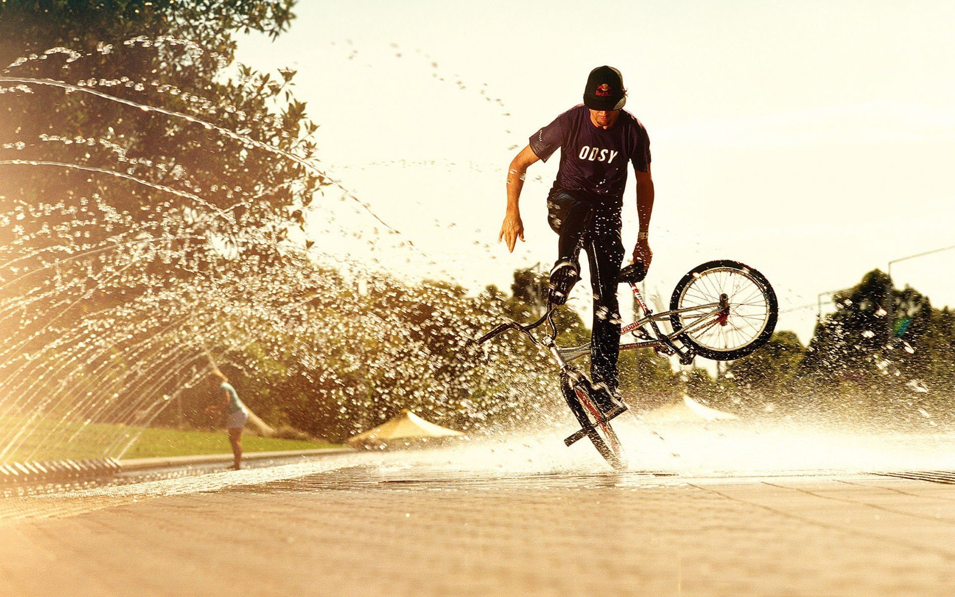 bmx stunt water spray sun summer background