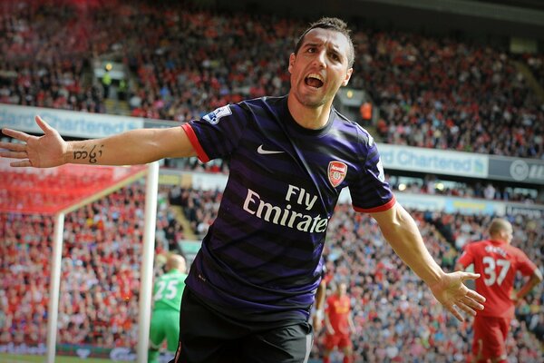 A football player at the stadium celebrates a goal