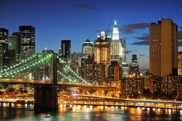 Beautiful Brooklyn bridge on the background of Brooklyn at night