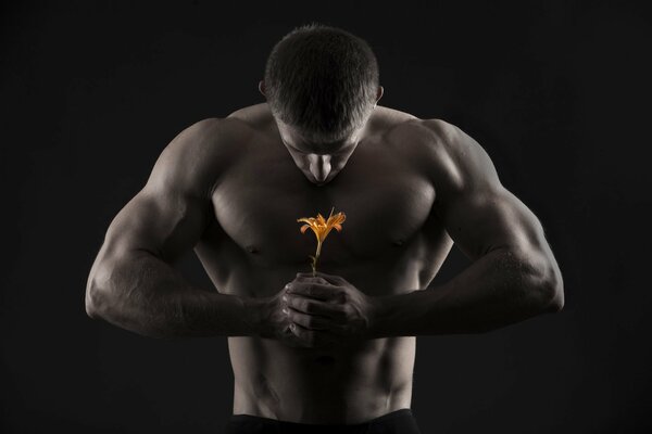An African American male athlete with an orange flower