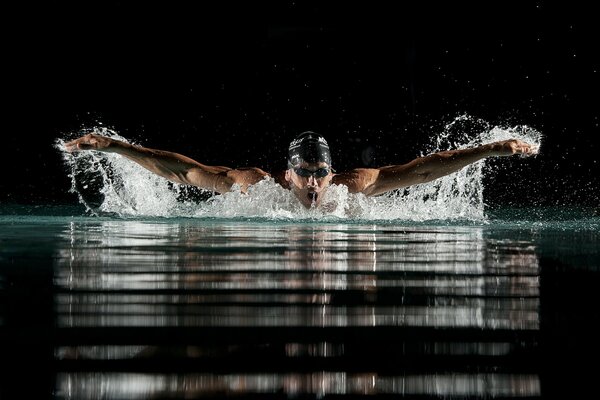 The swimmer emerged from the water to breathe air