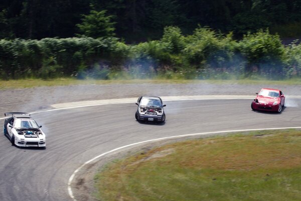 Three drifting cars on the track