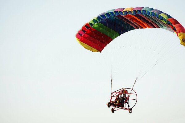 A multicolored parachute hovers in the sky