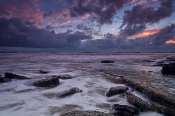 Evening, sunset by the sea on the rocky shore