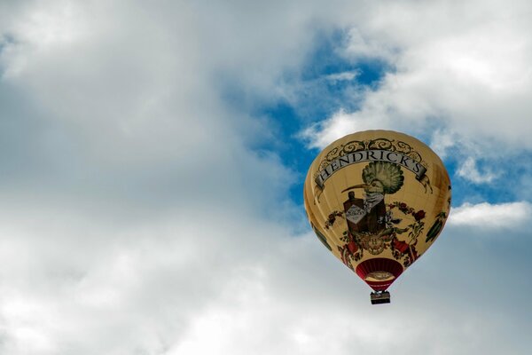 The balloon is flying high in the clouds