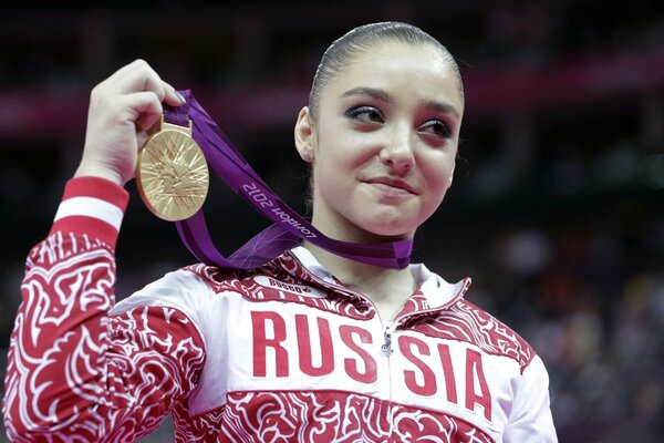Aliya Mustafina with a gold medal