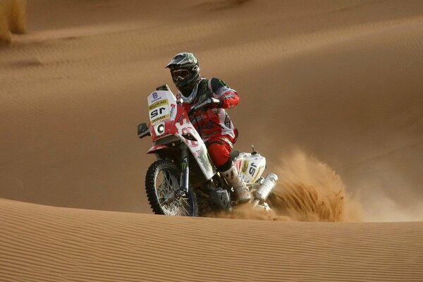 Motorcyclist on the background of sand dunes