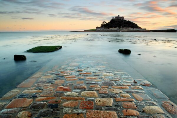 A stone path across the sea. Castle on the mountain
