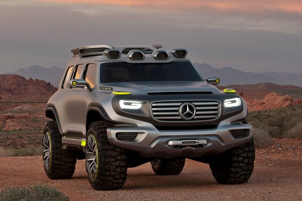 Silver Mercedes-benz rides through the desert