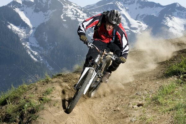 A cyclist in a helmet traveling on a mountain road