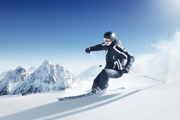 Skier on the background of snowy mountains