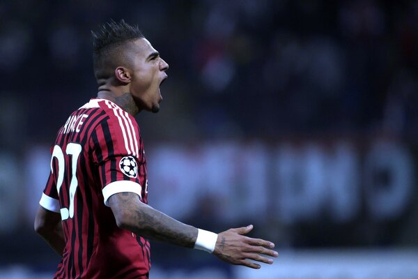 A black football player screams during a game