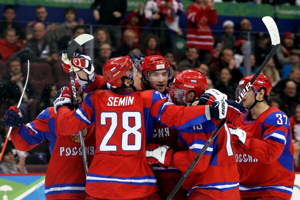 The national hockey team hugs on the ice