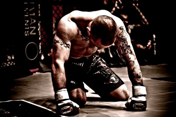 A former soldier with tattoos participates in mixed martial arts