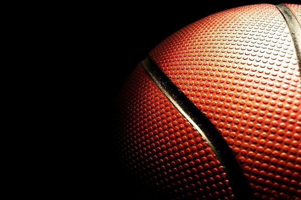 Textured surface of a basketball in the dark