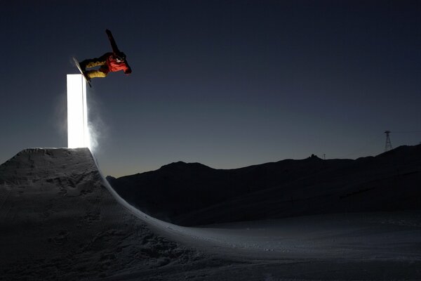 Snowboard ski jump on a quiet winter night