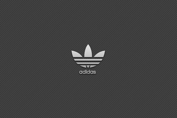 Emblema del marchio Adidas-trifoglio su sfondo grigio