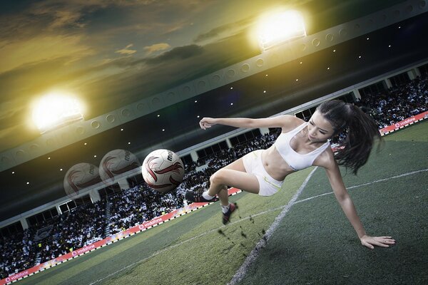 A girl in football kicks a ball in flight