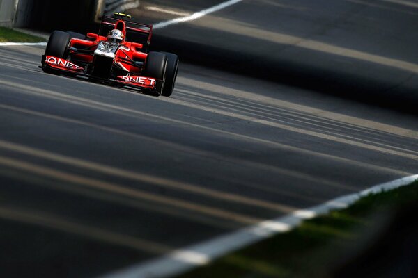 A racing car is racing along the track