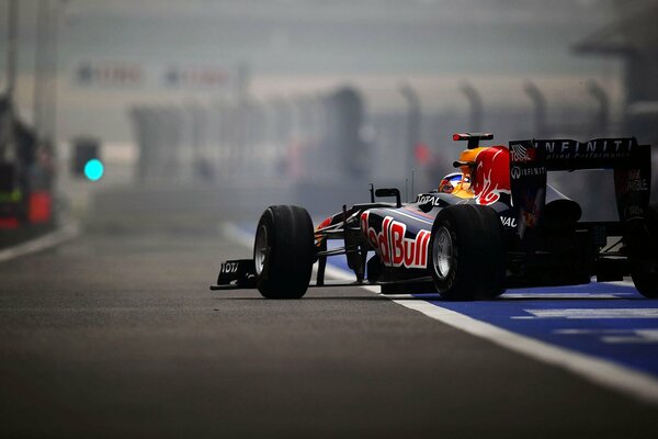 The Red Bull racing car is on the track