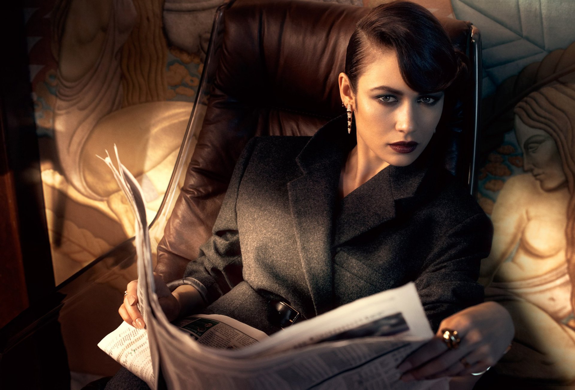 olga kurylenko modella attrice bruna look acconciatura trucco cappotto giornale poltrona servizio fotografico rivista vanity fair fotografo michelangelo di battista