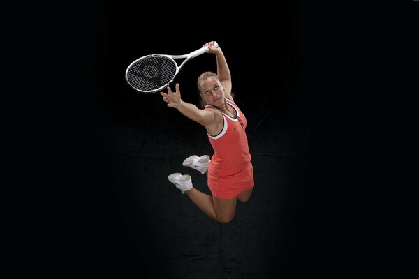 A girl in a red suit with a racket