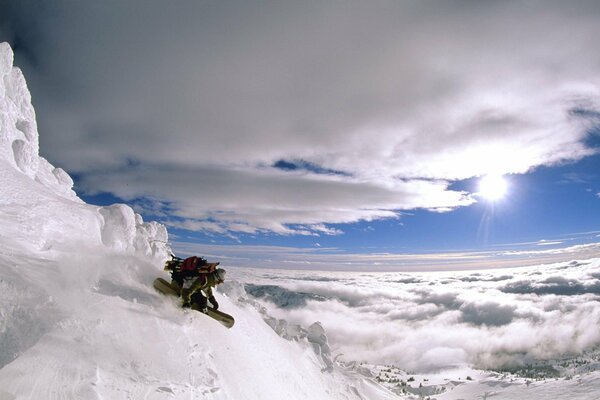 Snowboarder on a mountain peak in the clouds