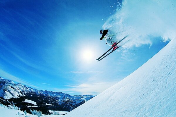 Skier goes down the mountain extremely, snow glistens in the sun