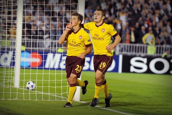 Football player Arshavin in a yellow uniform on the field