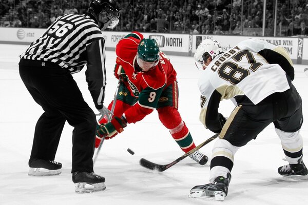 Photo on the ice at the rink kicking the puck