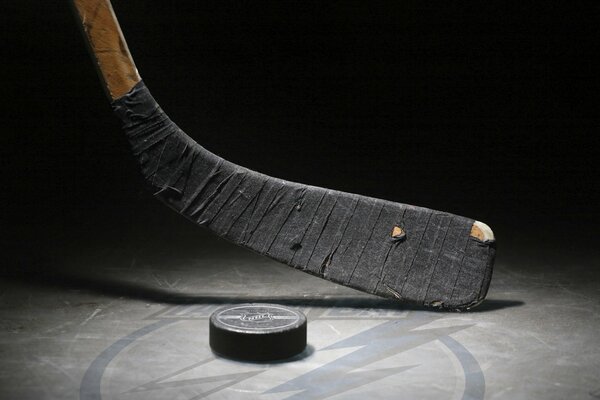 Working stick with a puck on ice