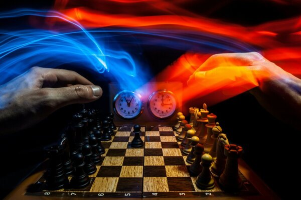 Chess is also a sport, but this photo shows hands playing this game