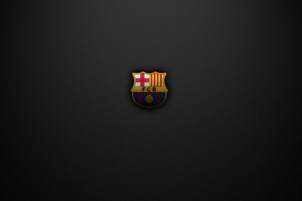 On a black background, the emblem of the Barcelona football club