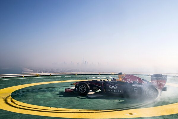 Red and black racing car makes a sharp U-turn