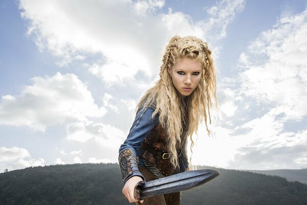 Vikings series actress Katherine Winnick holds a sword